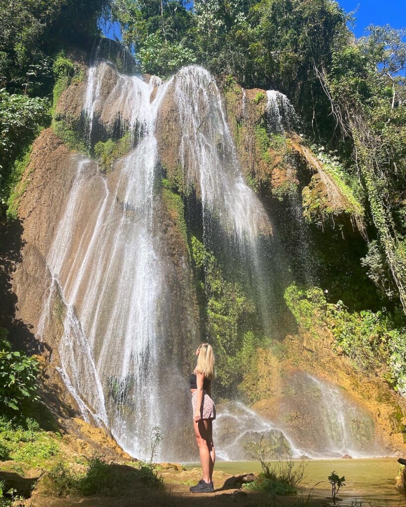 Girl gazes at El Rocio waterfall in Parque Guanayara Cuba.
