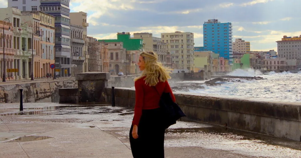 Woman wearing loose trousers and a red cardigan in Havana