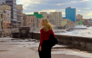 Woman wearing loose trousers and a red cardigan in Havana