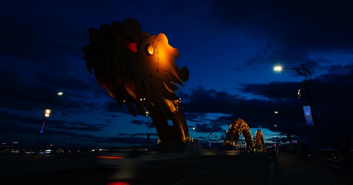 Dragon statue on a bridge at night