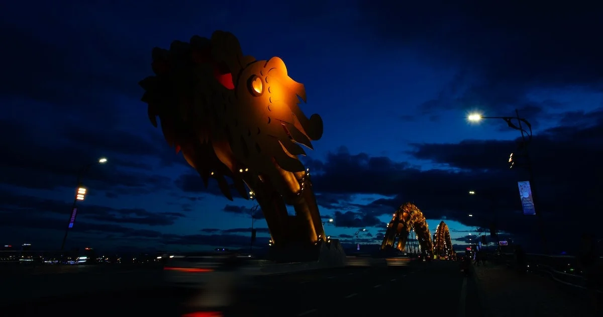 Dragon statue on a bridge at night
