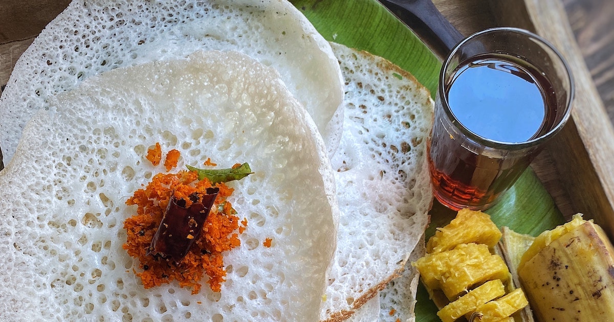 Fluffy appam rice pancakes on a banana leaf