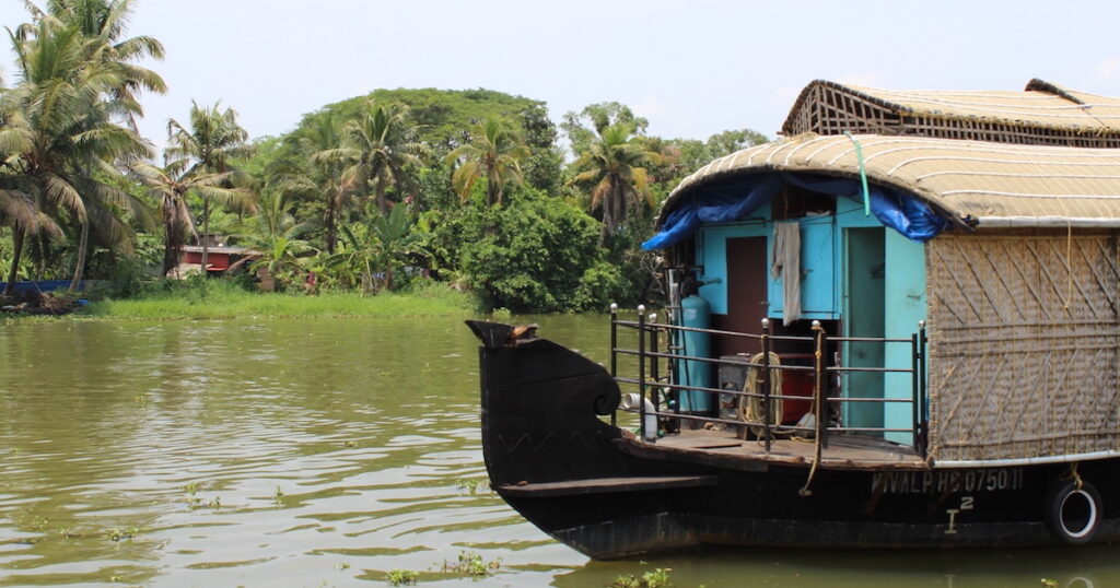 The helm of a houseboat gliding over Alleppey's backwaters