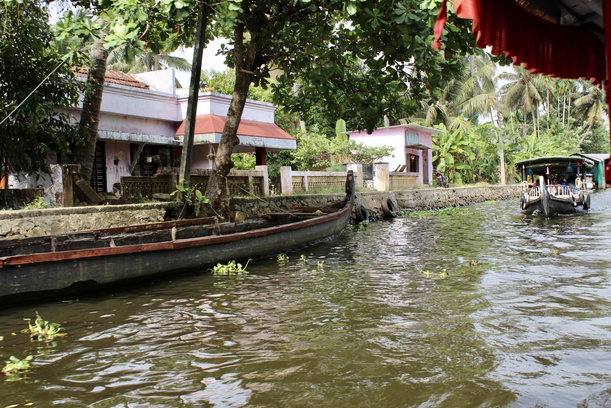 Shikara boats sailing over a canal in Alleppey