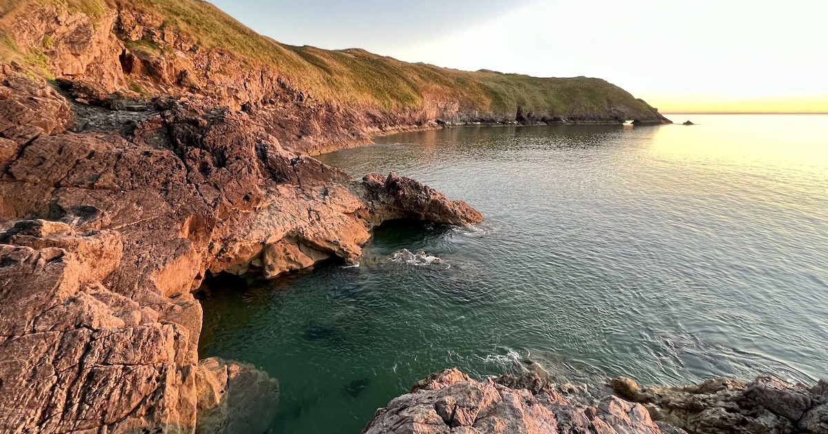 The tide is fully in at Blue Pool at Blue Pool Bay at sunset.