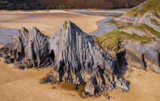 The three limestone cliffs at Three Cliffs Bay, one of the best beaches in Gower