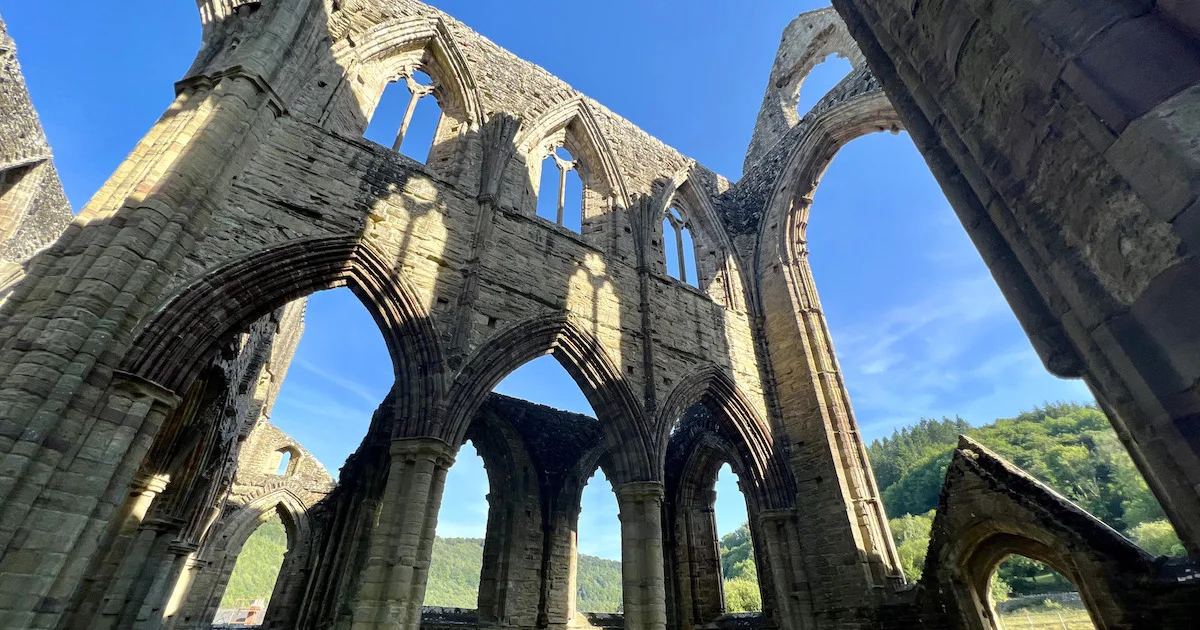 Gothic arches at Tintern Abbey frame the Wye Valley.