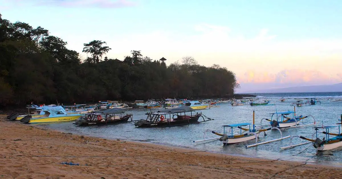 Balinese fishing boats on the small strip of sand at Padangbai Beach