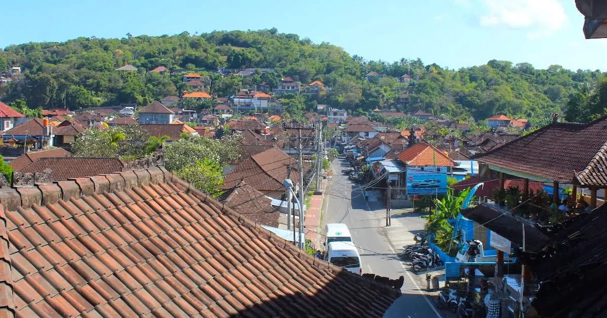 Padangbai street with forests and hills in the background