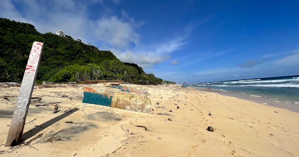 Two shipwrecks are buried in the sand on Pantai Nunggalan.