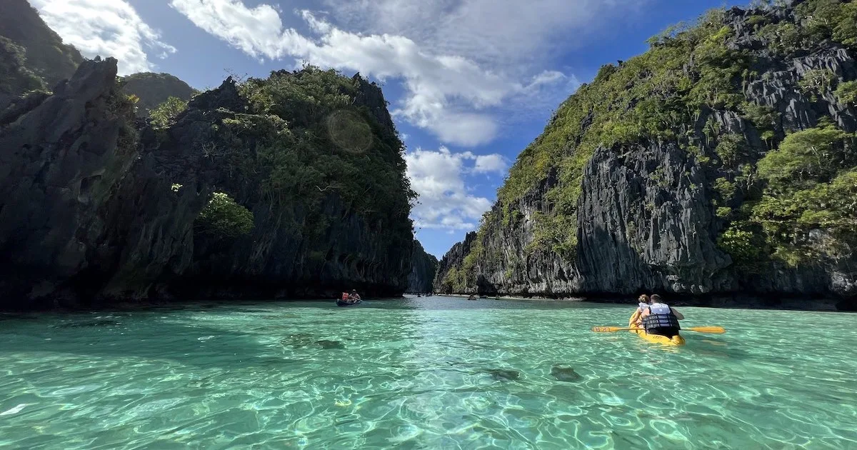 A kayak glides across Big Lagoon in El Nido.