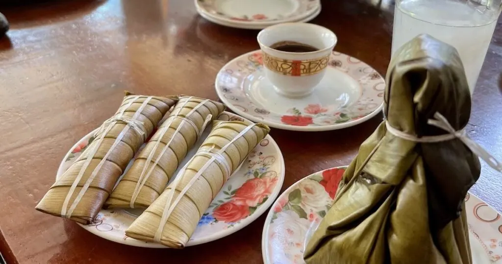 Steamed sticky rice enclosed in taro leaves.