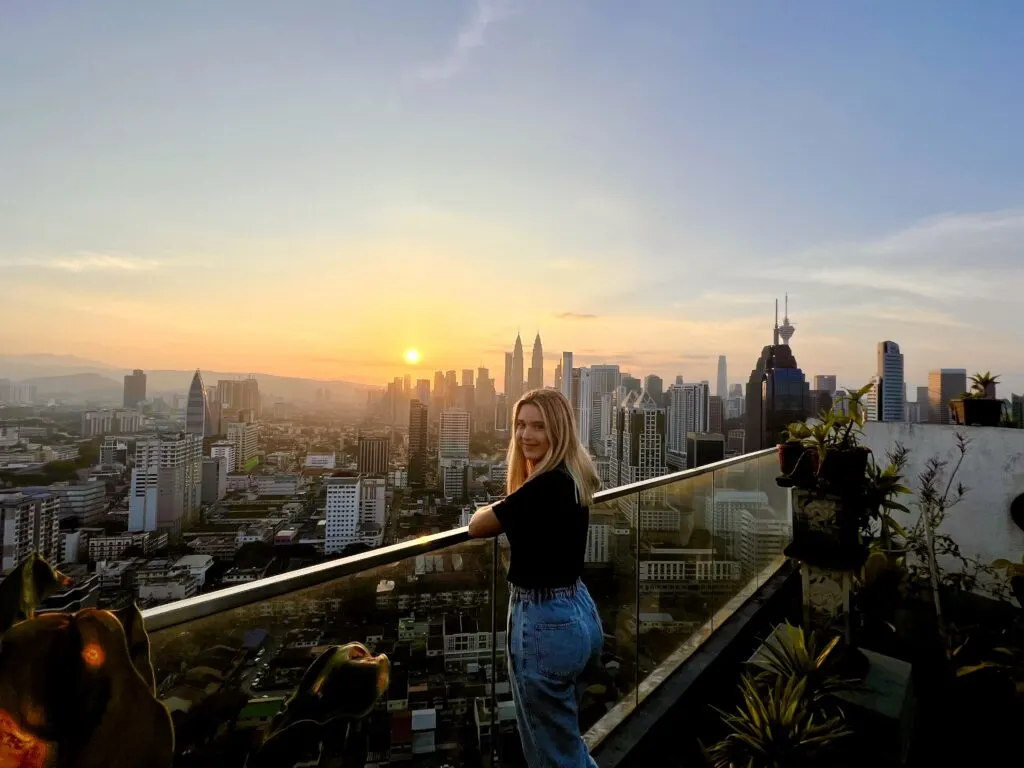 Katie Treharne looks over the skyline of Kuala Lumpur at sunrise.