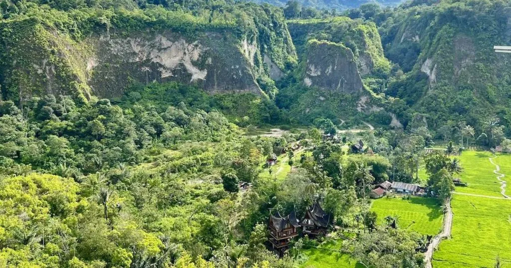 Sianok Canyon Valley panorama, showing cliffs and a homestay.