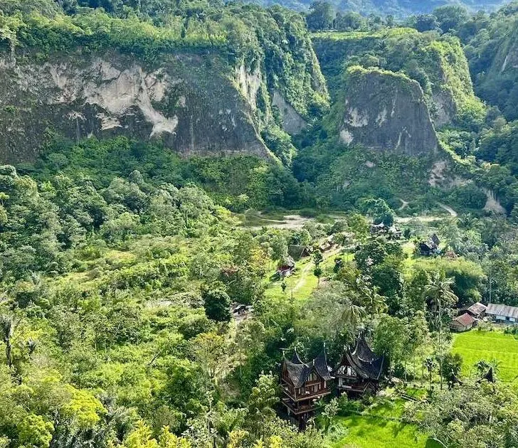 Sianok Canyon Valley panorama, showing cliffs and a homestay.