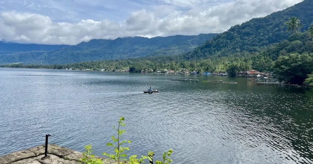 Fisherman rides a boat through Lake Maninjau in West Sumatra.