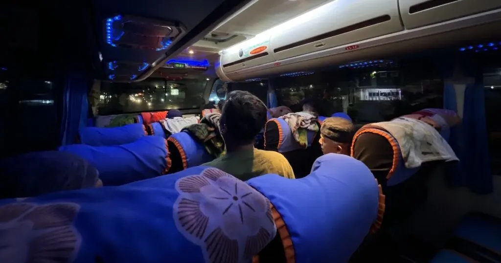 A local long-distance bus in Sumatra, featuring blankets and air conditioning.
