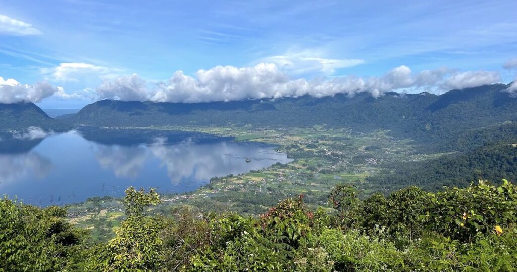 Viewpoint at Puncak Lawang, overlooking a bowl of rice terraces around Lake Maninjau.