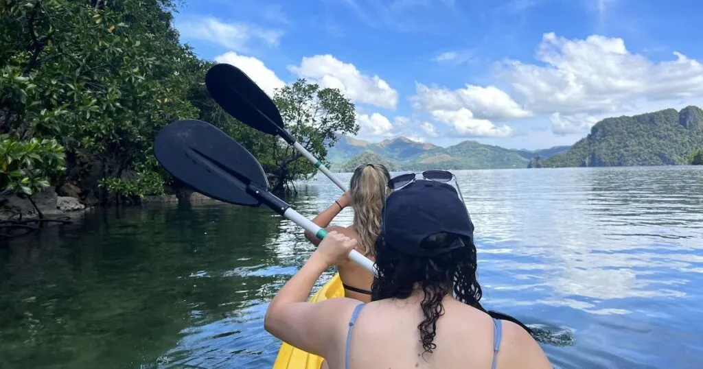 Two girls kayaking through Small Lagoon in Coron.