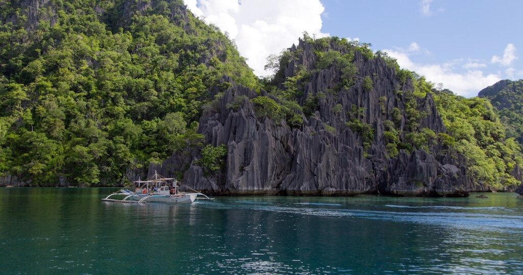 Bangka Boat glides past the entrance to Twin Lagoon in Coron.