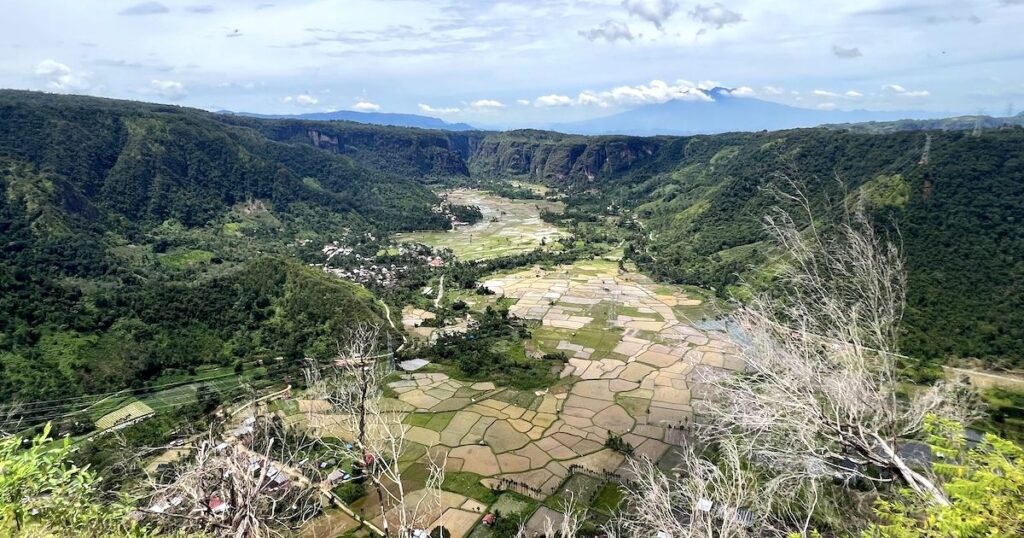 View of rice terraces and cliffs from the top of the Harau Valley hike.
