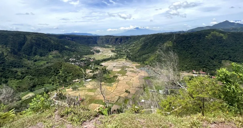 View over Harau Valley, rice terraces and a volcano from a hike in Harau.