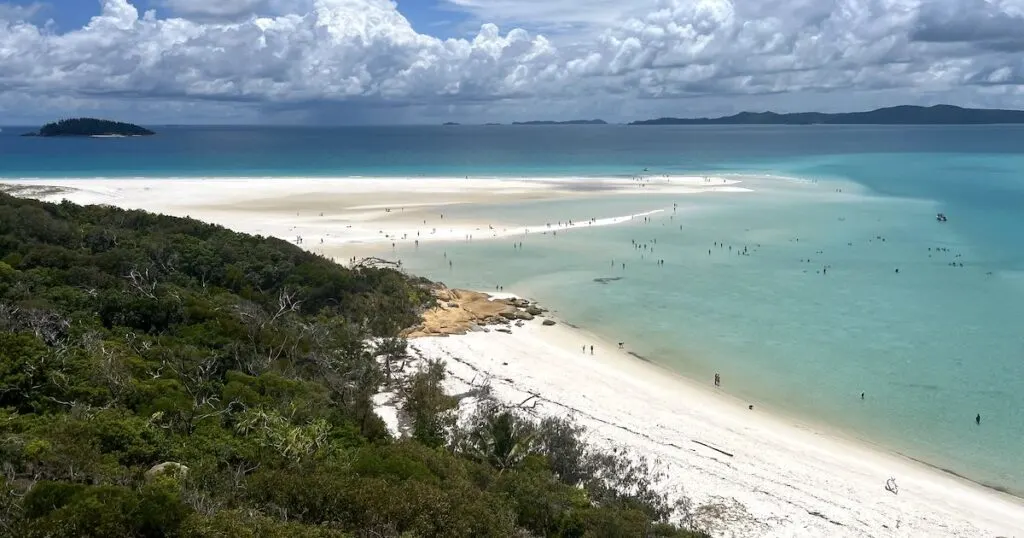 White silica sand at Whitehaven Beach dotted with people, viewed from a lookout.