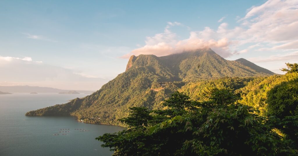 A forest-covered mountain on the coast of Anilao in the Philippines.