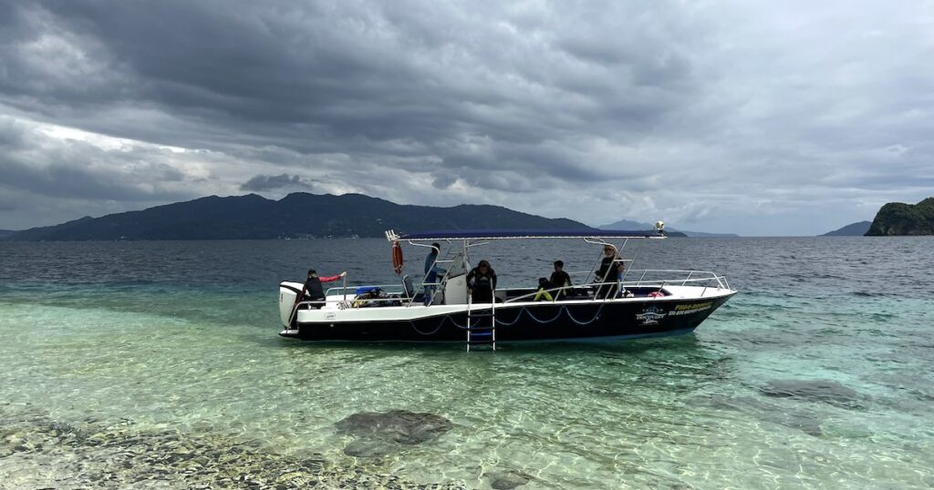 Anilao diving speedboat rests next to Sombrero Island in Anilao.