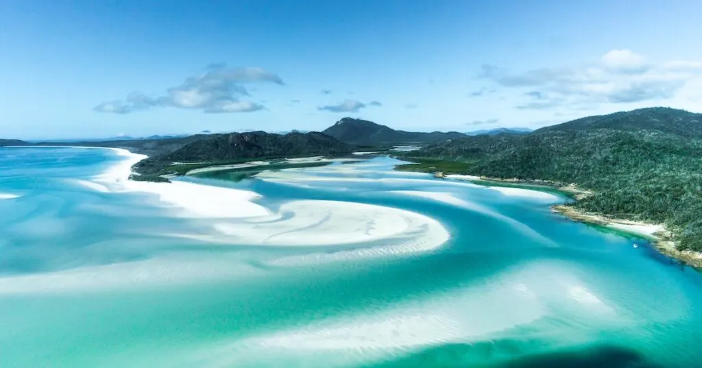 Streaks of silicone sand and blue ocean at Whitehaven Beach in the Whitsundays.