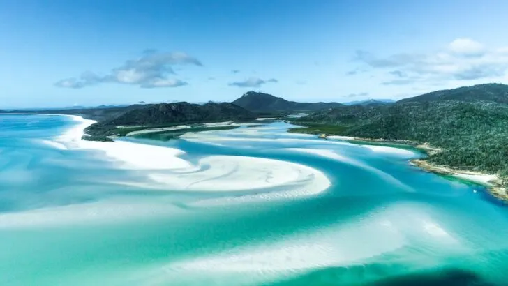 Streaks of silicone sand and blue ocean at Whitehaven Beach in the Whitsundays.