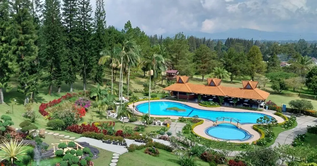 Sinabung Hills Resort in Berastagi with a large swimming pool and landscaped garden.