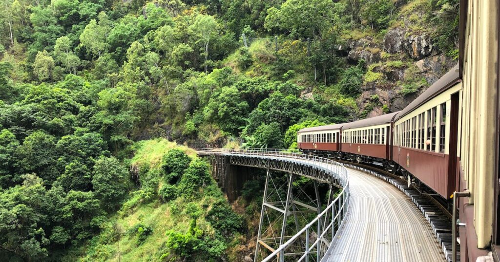 The Kuranda Scenic Railway passing over a bridge between Cairns and Karunda, a popular Cairns itinerary item.