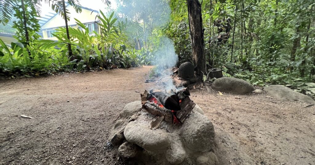A fire burns in the rainforest, part of an aboriginal tour in Cairns.