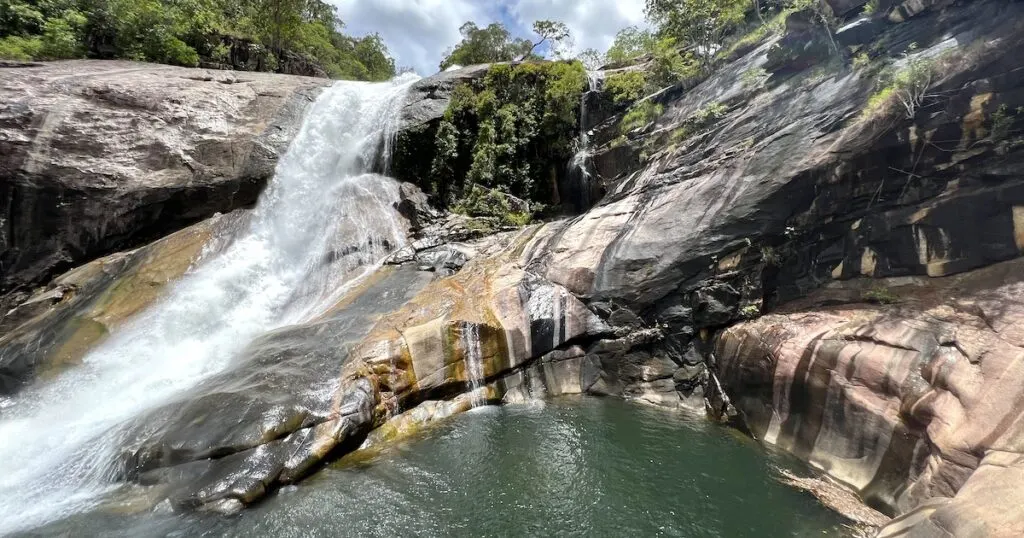 Waterfall tumbles down rocks into a pool at Josephine Falls in Wooroonooran.