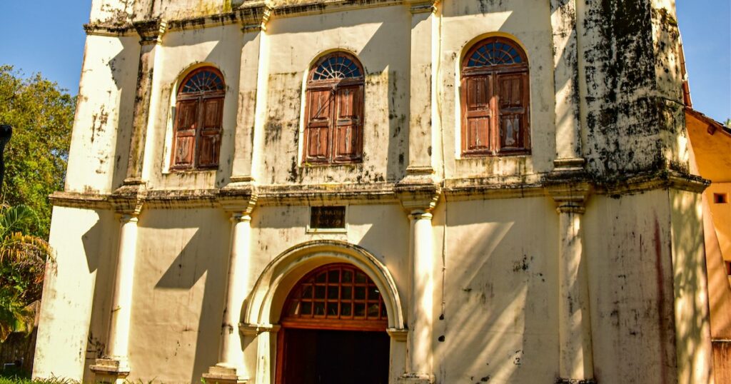 The worn white walls and entrance to St Francis Church in Kochi.