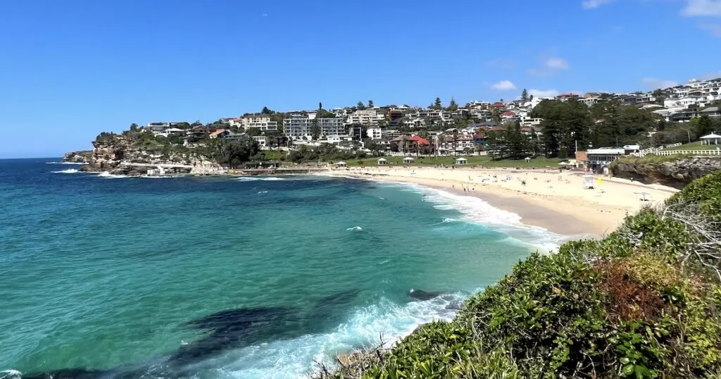 Small white beach with turqouise water along the Coogee to Bondi coastal walk in Sydney.