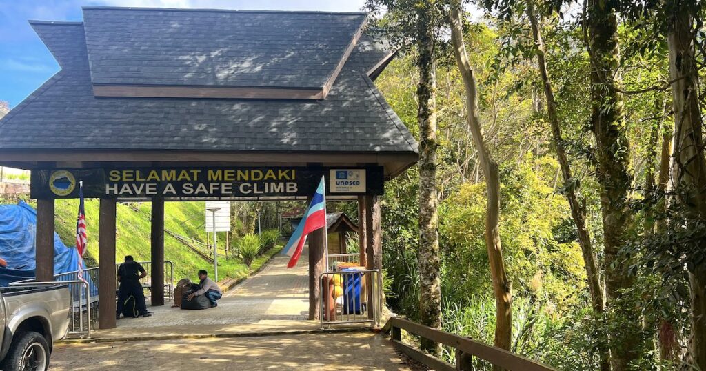 Timpohon Gate, a large wooden gate wishing hikers a safe climb at the entrance to Kinabalu park.